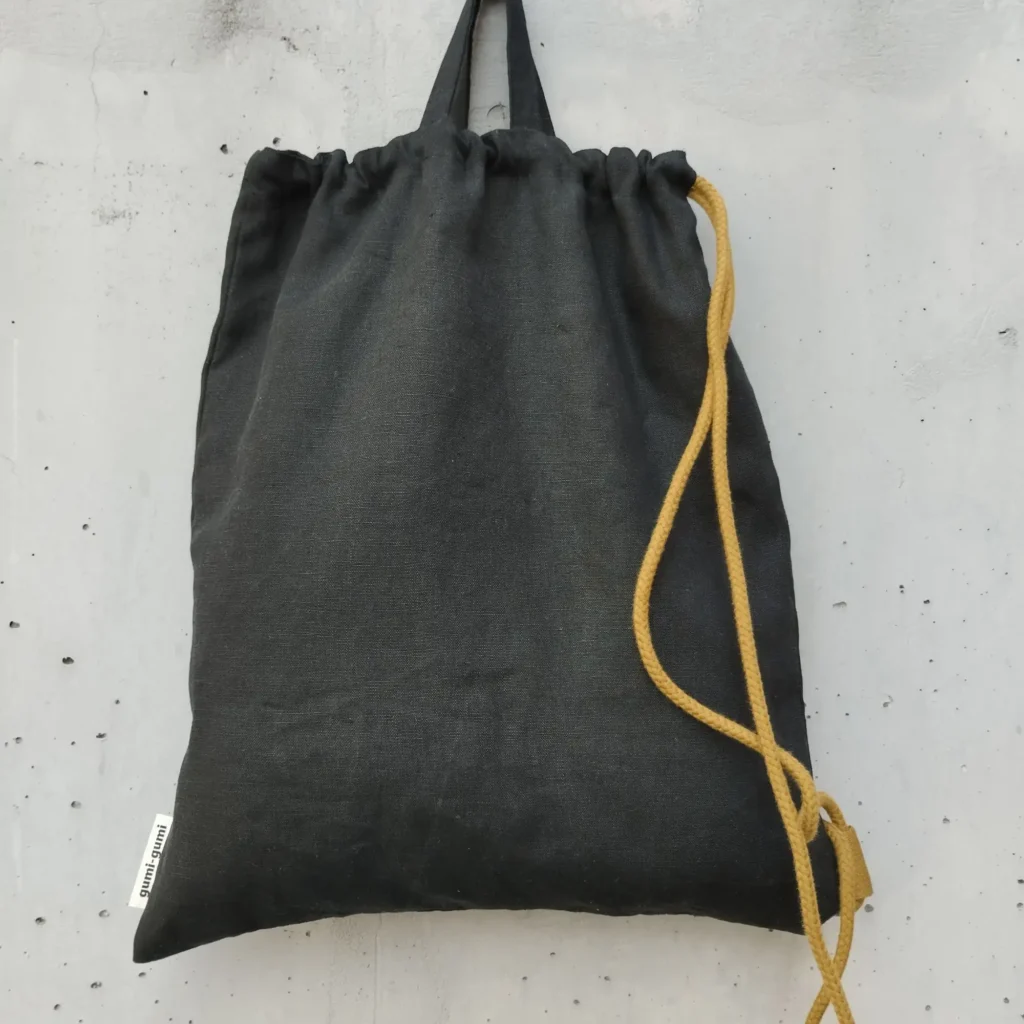 Black linen drawstring backpack with golden brown cotton cord and top handles — Nox by gumi-gumi